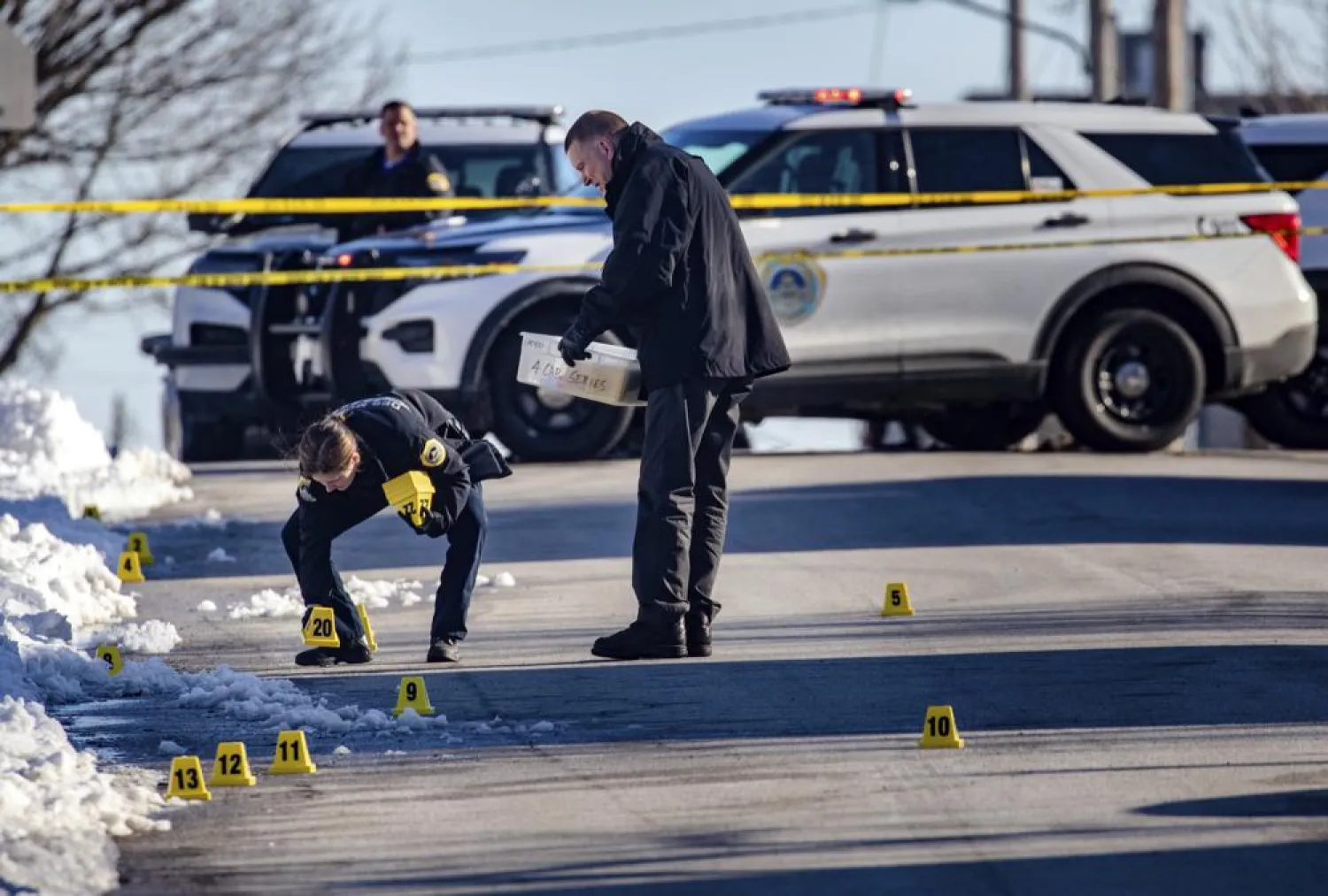 Police investigate a shooting outside of East High School in in Des Moines, Iowa, on Monday, March 7, 2022. (Zach Boyden-Holmes/The Des Moines Register via AP)
