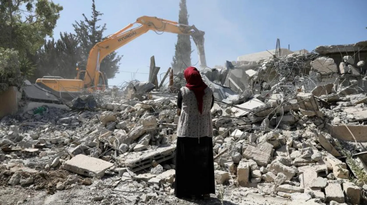 Fawzia stands on the ruins of her house, after her Palestinian ex-husband demolished the dwelling to not face the prospect of Israeli settlers moving in after he lost a land ownership case in Israeli courts, in the East Jerusalem neighborhood of Beit Hanina, July 19, 2018. REUTERS/Ammar Awad
