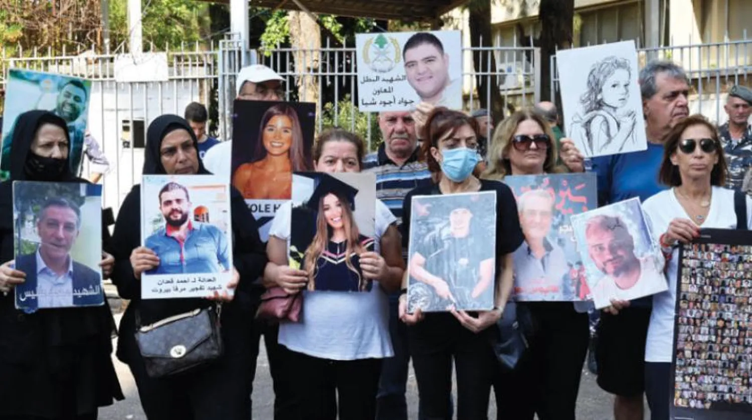 Relatives of some of the victims of the August 2020 Beirut port blast carry their pictures and banners during a protest outside the Justice Palace, in Beirut, Lebanon September 7, 2022 (EPA)
