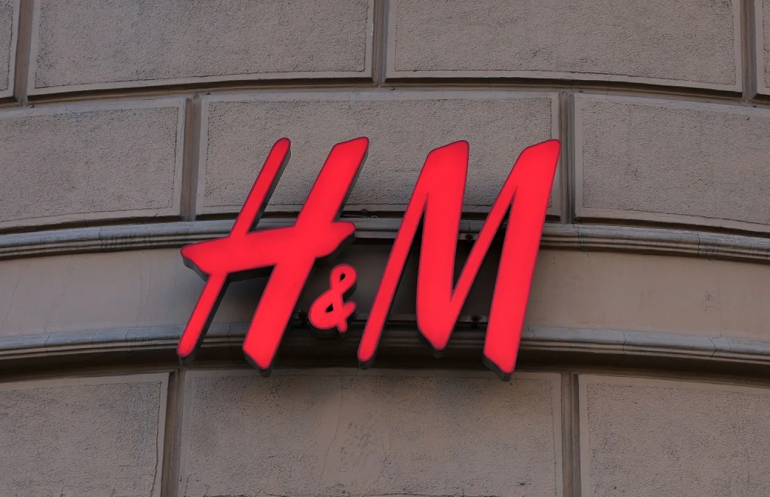 The logo of H&M is on display outside a store on the day it closes, as the fashion retailer exits the Russian market, in Moscow, Russia November 30, 2022. (Reuters)
