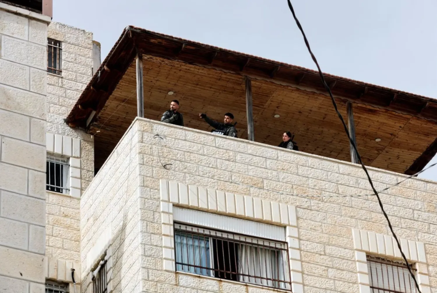 Israeli Border police officers stand at the house of Palestinian gunman Khaire Alkam in A-Tur in East Jerusalem, after Alkam shot dead at least seven people near a synagogue in Neve Yaacov which lies on occupied land that Israel annexed to Jerusalem after the 1967 Middle East war, January 28, 2023. REUTERS/Ammar Awad

