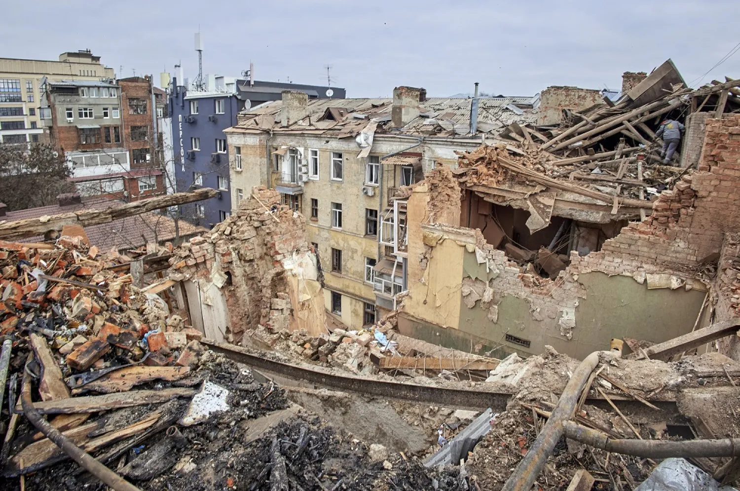 Ukrainian rescuers work on a residential building hit in Russian overnight shelling in Kharkiv, Ukraine, 30 January 2023. (EPA)
