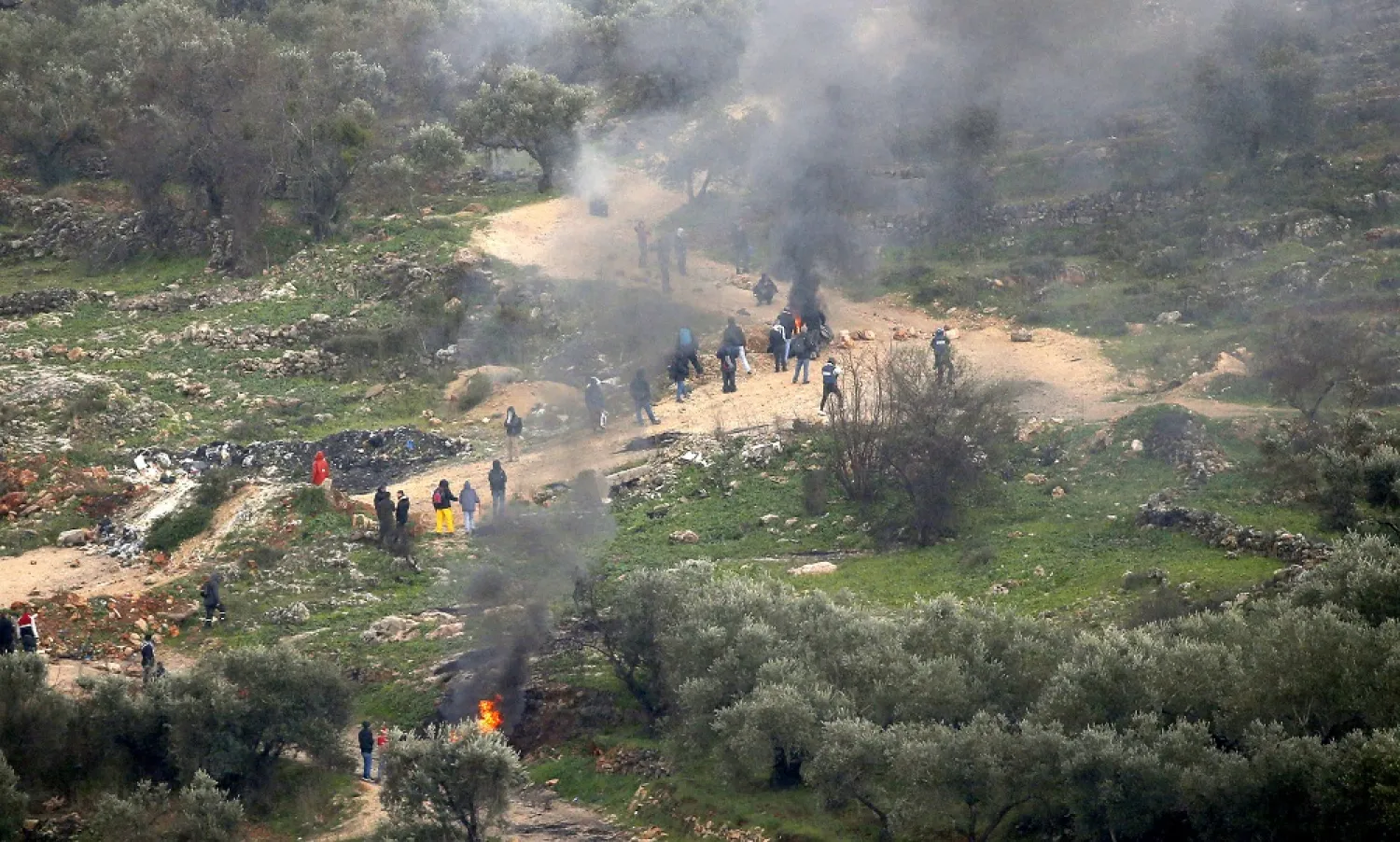 Palestinians burn tires during clashes after a protest against Israeli settlements at Beita village near the West Bank city of Nablus, 03 February 2023. (EPA)