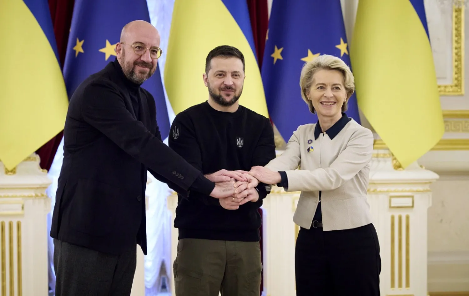 Ukrainian President Volodymyr Zelenskyy, center, European Commission President Ursula von der Leyen, right, and European Council President Charles Michel shake hands during the EU-Ukraine summit in Kyiv, Ukraine, Friday, Feb. 3, 2023. (Ukrainian Presidential Press Office via AP) 