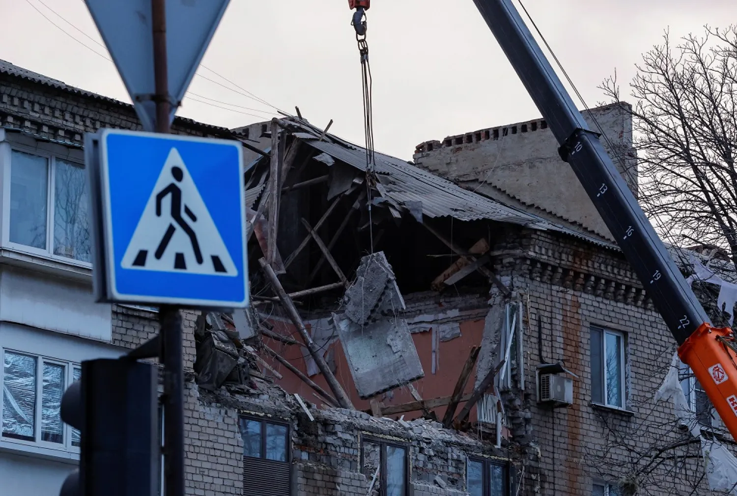 Rescuers use a crane to remove debris of a multistorey residential building damaged in recent shelling in the course of Russia-Ukraine conflict in Donetsk, Russian-controlled Ukraine, February 4, 2023. (Reuters)