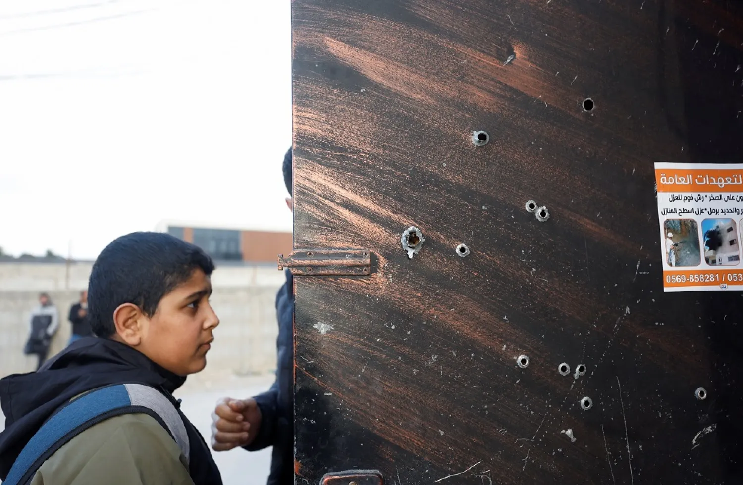 Bullet holes are pictured on a door at the scene where Israeli forces killed a number of armed fighters during a raid at a refugee camp near the city of Jericho in the Israeli-occupied West Bank, February 6, 2023. (Reuters)