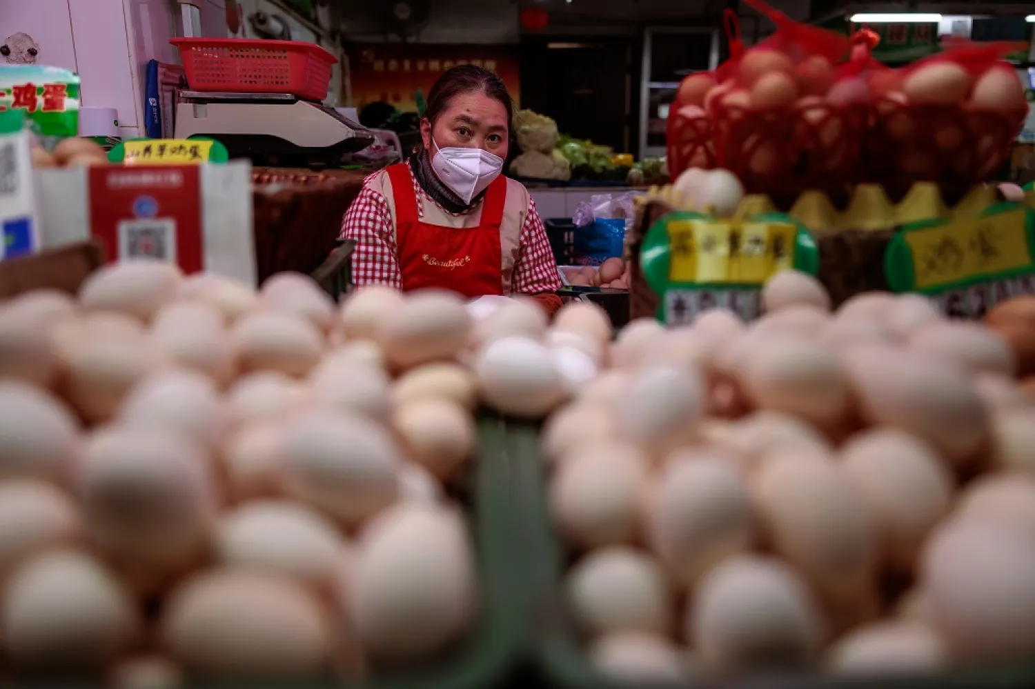 A woman sales eggs on the wet market, in Shanghai, China, 03 February 2023. (EPA)