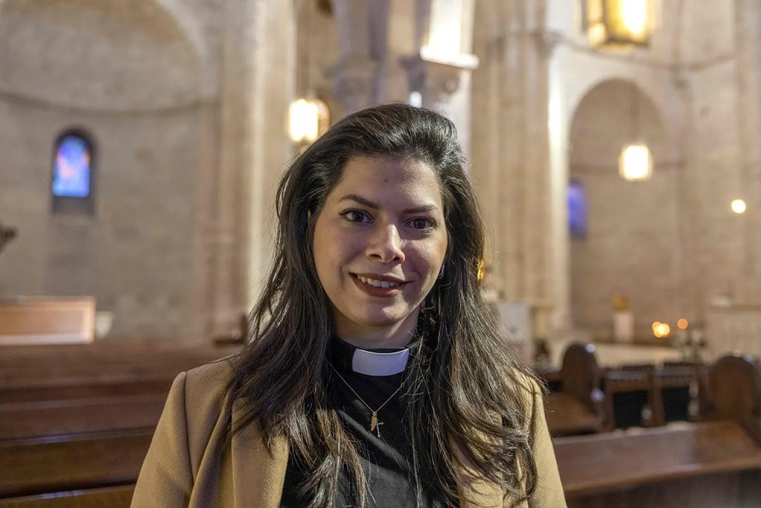 Sally Ibrahim Azar, first female pastor in the Holy Land of the Lutheran Church, poses for a picture at the Lutheran Church in the Jerusalem's Old City, on January 25, 2023. (AFP)
