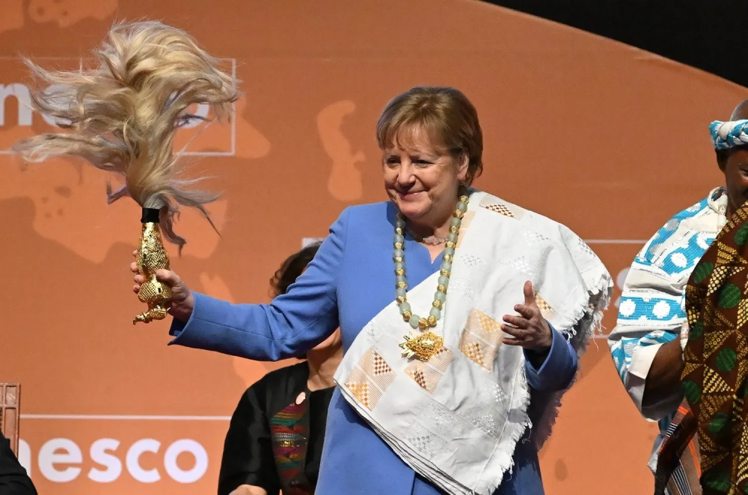 Former German Chancellor Angela Merkel gestures after receiving the Félix Houphouët-Boigny Peace Prize at the Félix Houphouët-Boigny Foundation in Yamoussoukro on February 8, 2023. (AFP) 
