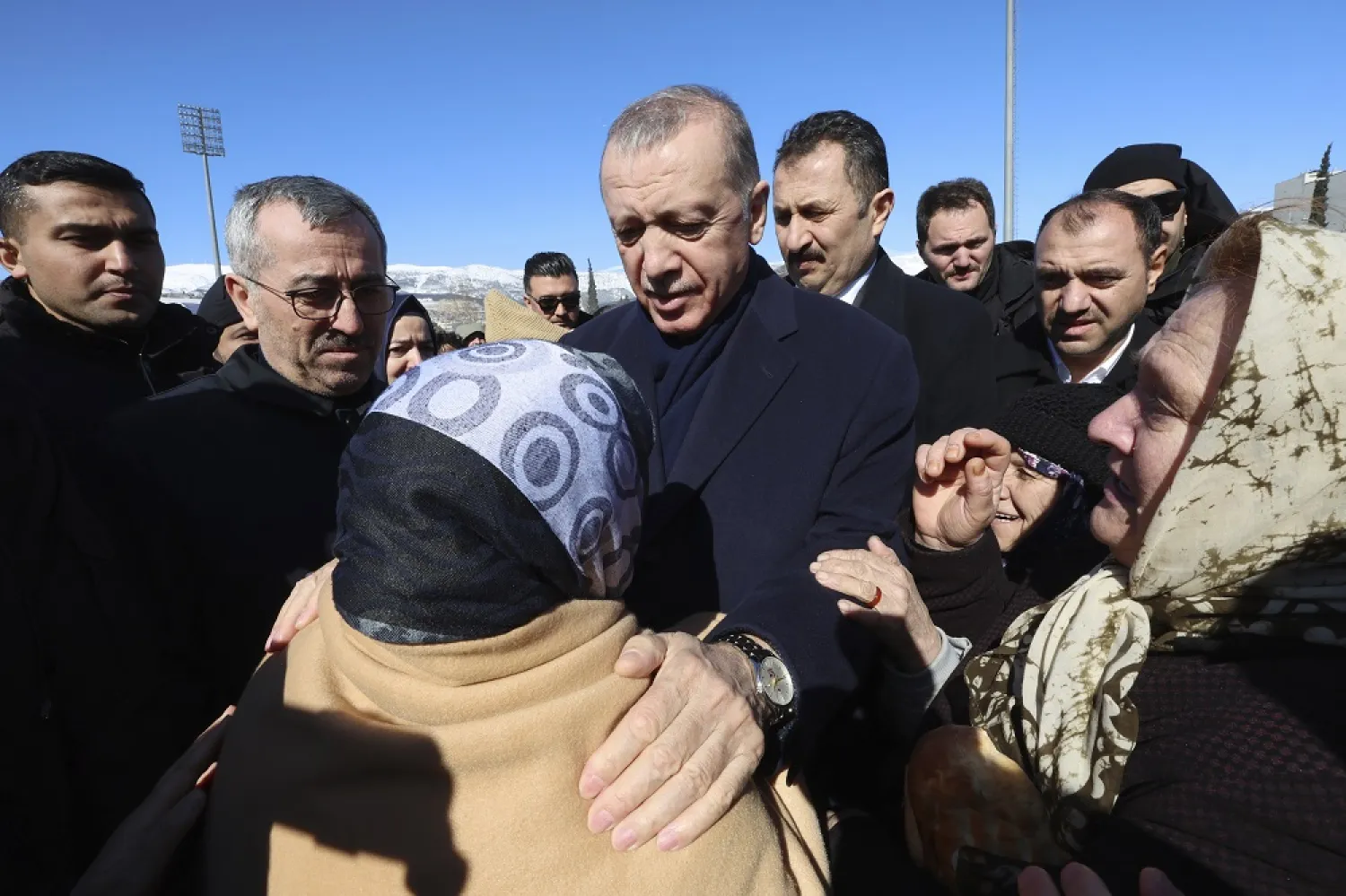 Türkiye's President Recep Tayyip Erdogan and a survivor speak as he visits the city center destroyed by Monday earthquake in Kahramanmaras, southern Türkiye, Wednesday, Feb. 8, 2023. (Turkish Presidency via AP ) 