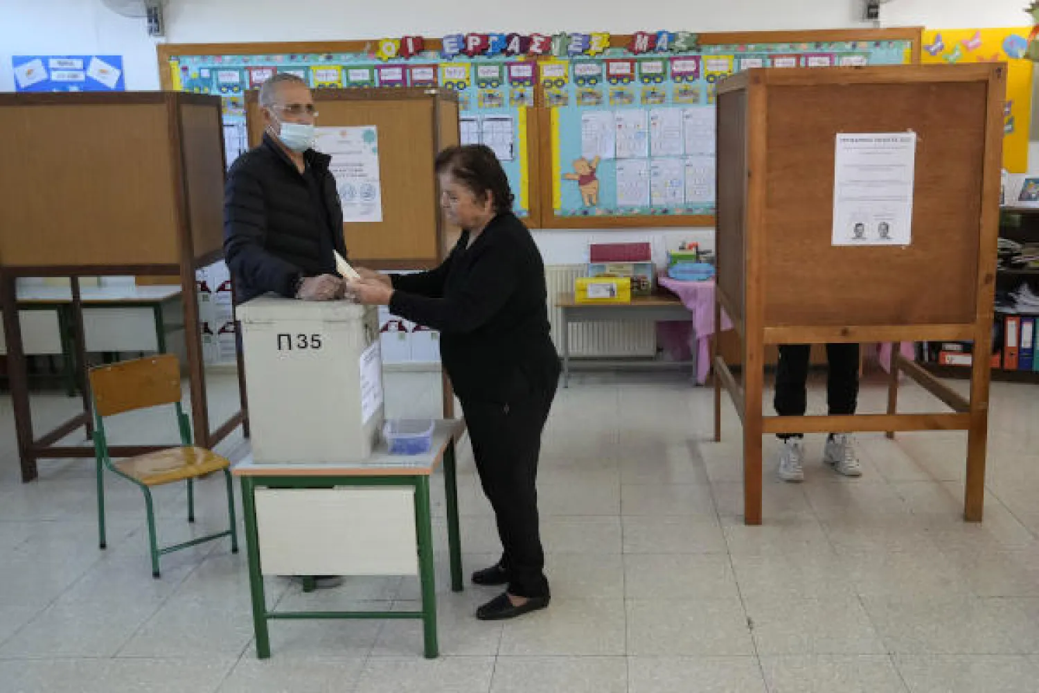 An elderly woman casts her vote during the presidential election in Geroskipou in southwest coastal city of Paphos, Cyprus, Sunday, Feb. 12, 2023. (AP Photo/Petros Karadjias)
