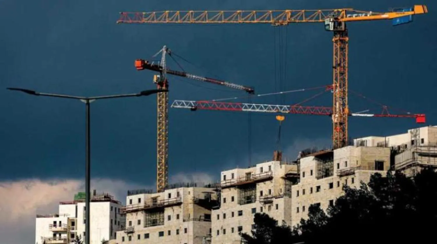 Cranes work in the Ramat Shlomo settlement in Jerusalem, which was annexed by Israel (AFP)