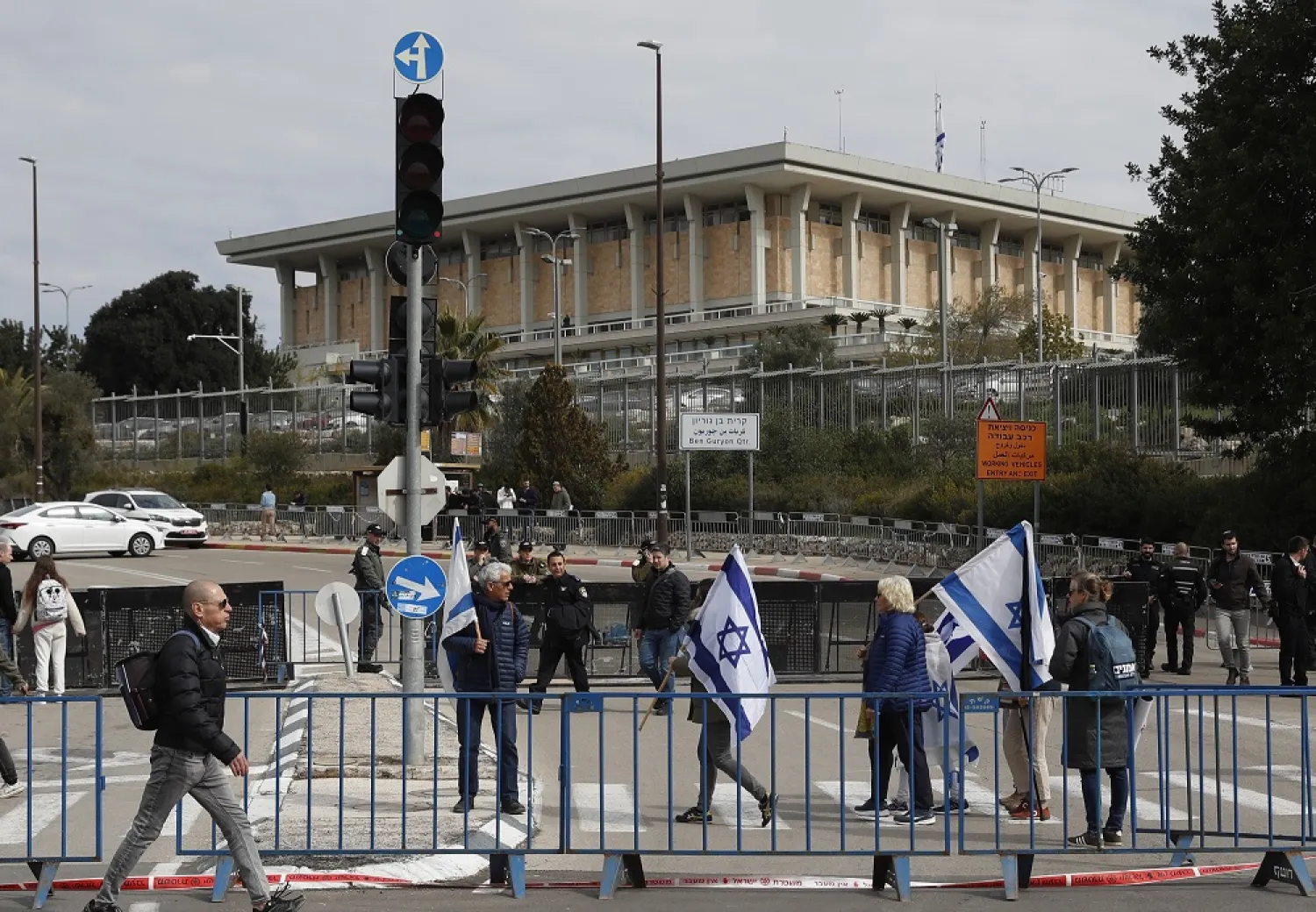 Protesters hold Israeli flags ahead of an anti-government rally next to the Israeli parliament in Jerusalem, 13 February 2023. (EPA)