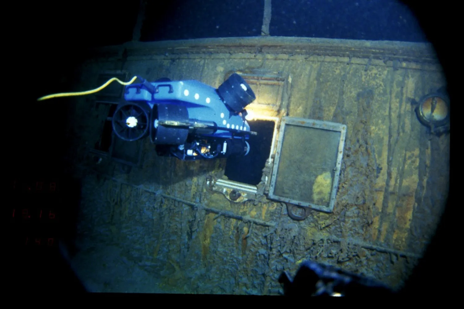 In this image provided by the Woods Hole Oceanographic Institution, an underwater remote vehicle examines an open window of the Titanic 12,500 feet (3.8 kilometers) below the surface of the ocean, 400 miles (640 kilometers) off the coast of Newfoundland, Canada in 1986. (Woods Hole Oceanographic Institution via AP)
