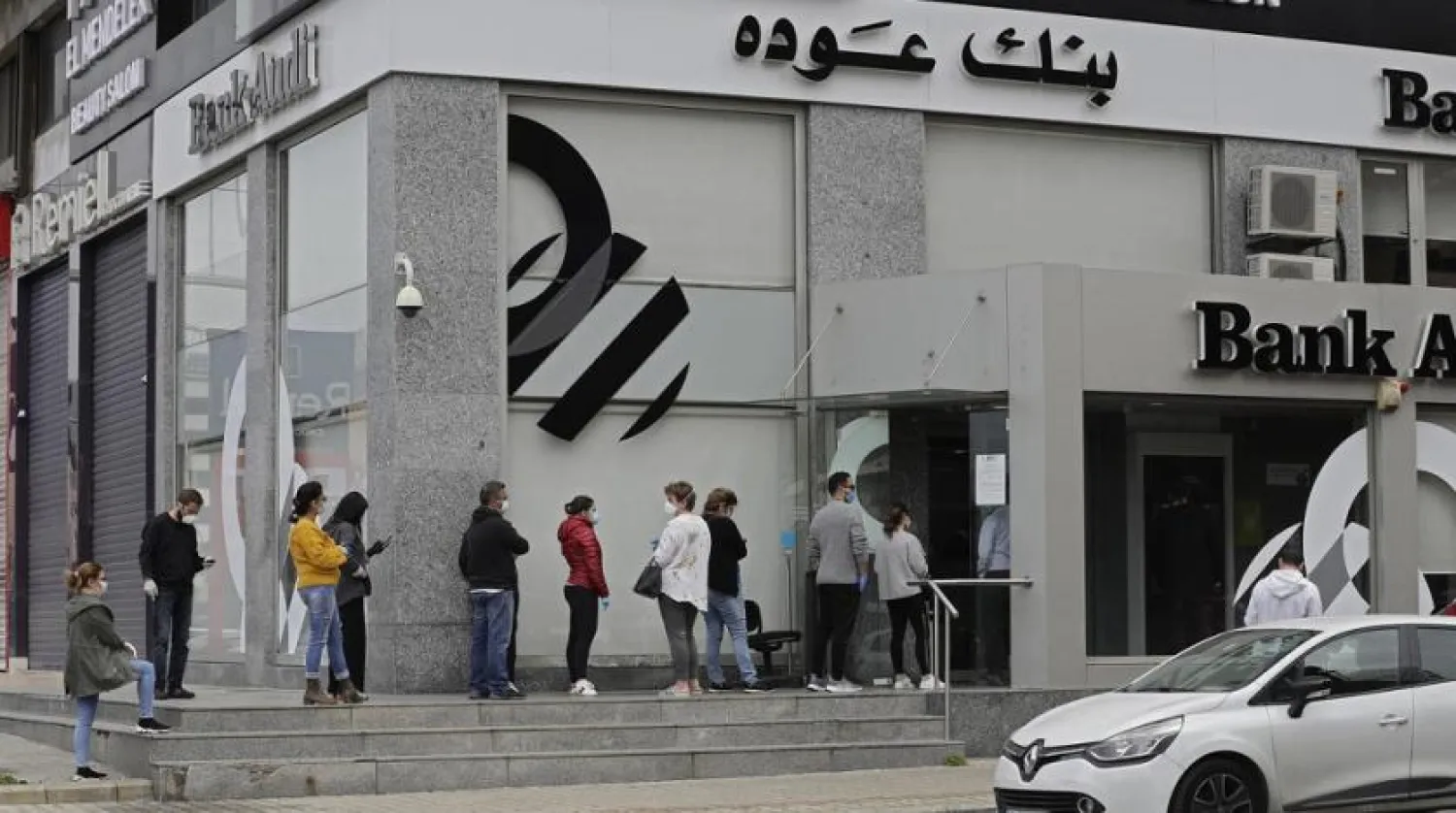 File photo: People queue outside a bank in Beirut on March 29, 2020. (AFP)