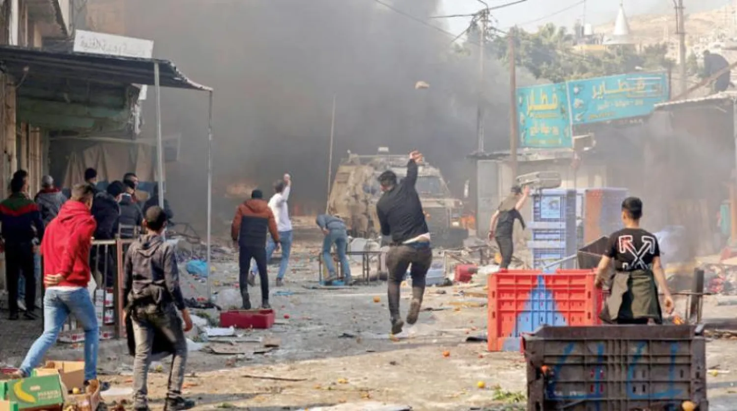 Palestinians clash with Israeli security forces during a raid in the occupied West Bank city of Nablus, on Feb. 22 (AFP)

