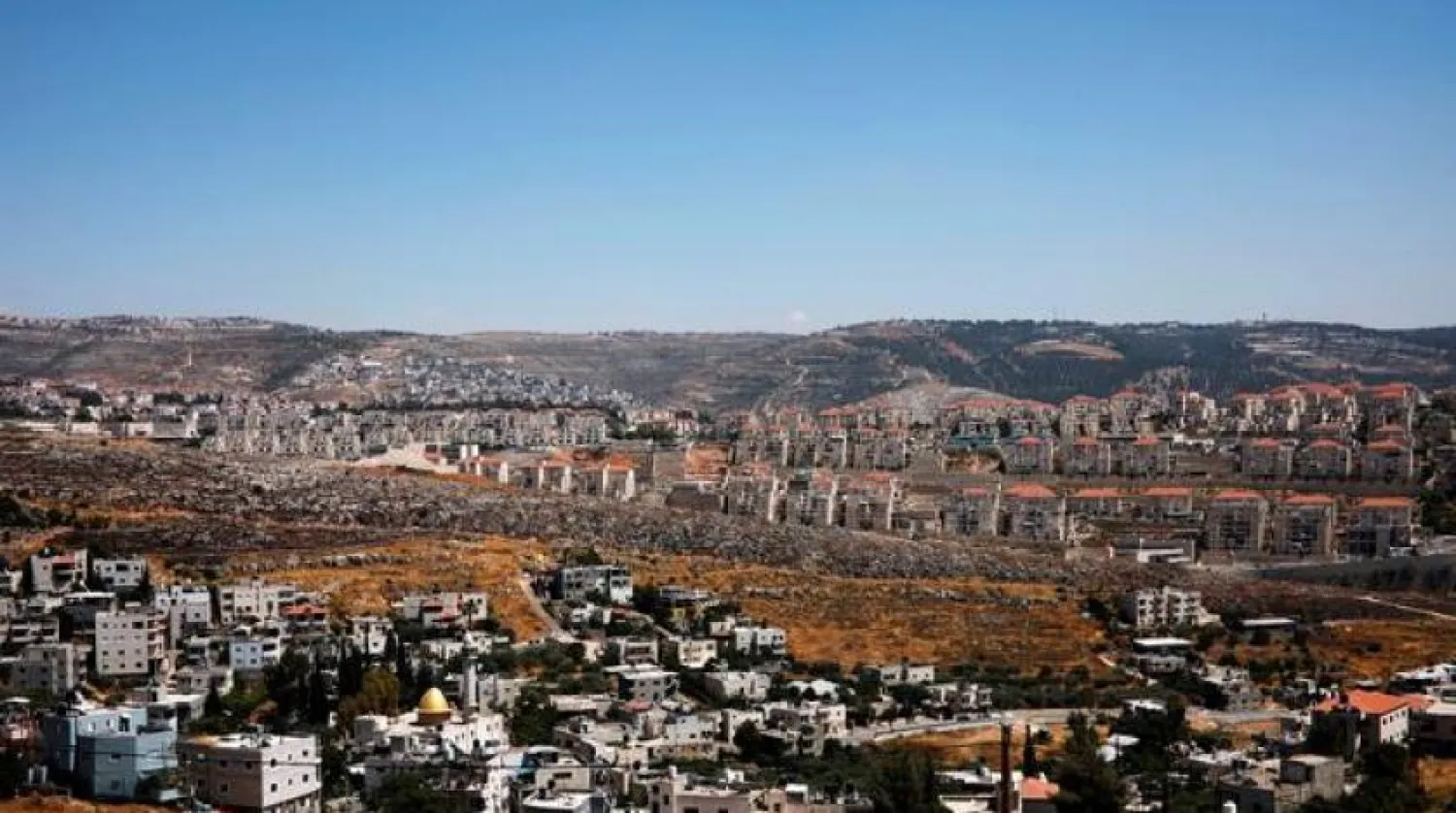 FILE PHOTO: A general view shows Palestinian houses in the village of Wadi Fukin as the Israeli settlement of Beitar Illit is seen in the background, in the occupied West Bank, June, 19, 2019. - Reuters
