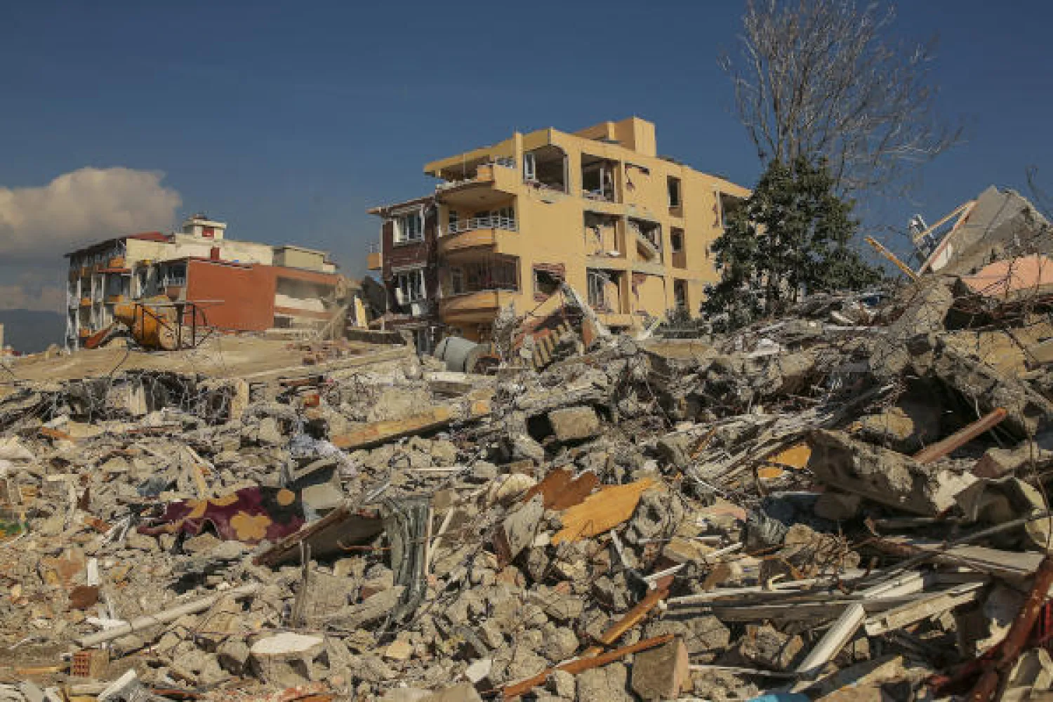 Rubbles from destroyed buildings are scattered following the earthquake in Samandag, southern Türkiye, Wednesday, Feb. 22, 2023. (AP Photo/Emrah Gurel)
