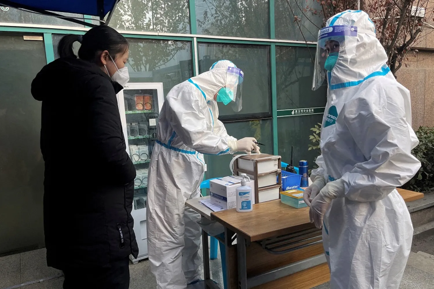 A medical worker in a protective suit registers information for a patient at the entrance to the fever clinic of the Central Hospital of Wuhan, amid of the coronavirus disease (COVID-19) outbreak, in Wuhan, Hubei province, China December 31, 2022. (Reuters)