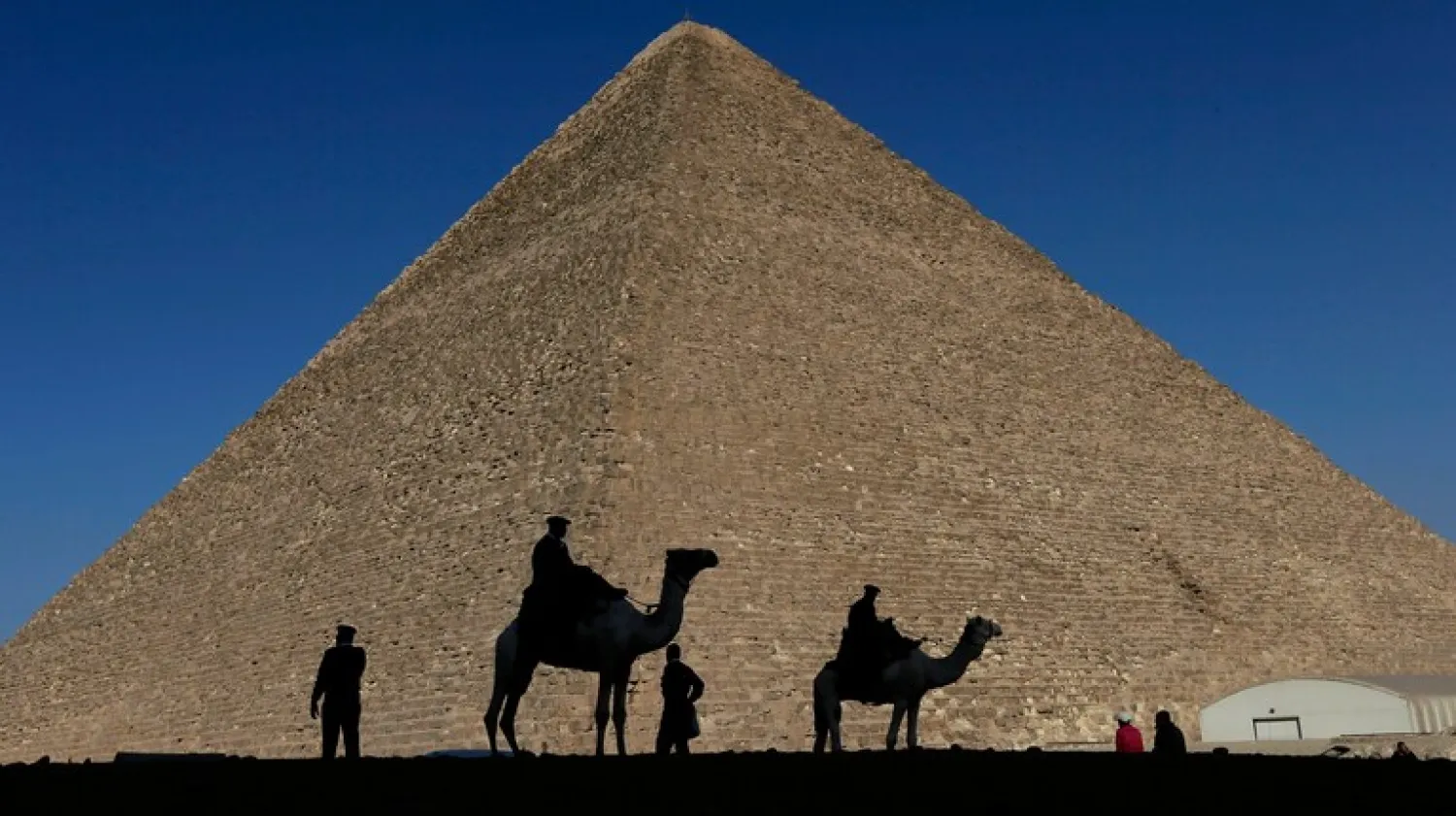 FILE - Policemen are silhouetted against the Great Pyramid in Giza, Egypt, Dec 12, 2012. (AP Photo/Hassan Ammar, File)