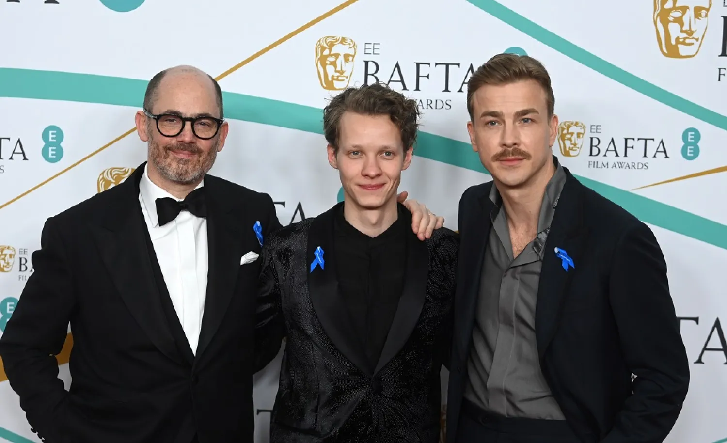 Edward Berger (L), Feliz Kammerer (C) and Albrecht Schuch (R) arrive for the 2023 EE BAFTA Film Awards ceremony at the Southbank Center in London, Britain, 19 February 2023. (EPA)