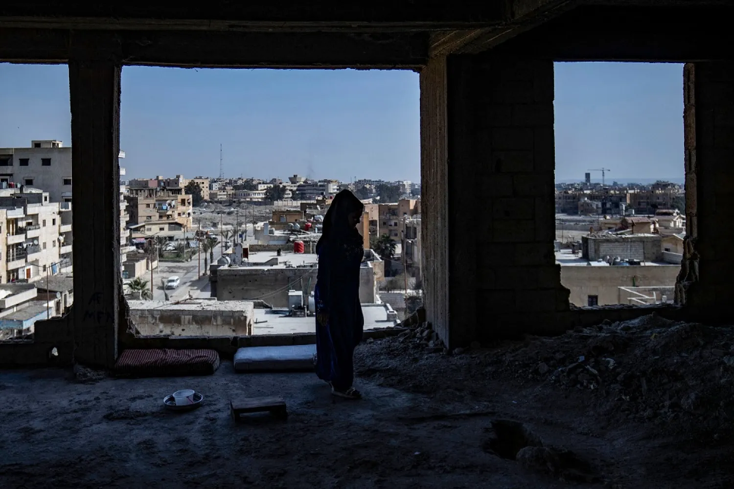 A displaced Syrian woman living in war-damaged buildings, are pictured in Syria's opposition-held northern city of Raqqa on March 1, 2023, amid fears that the already fragile dwellings will not withstand an earthquake.(AFP)