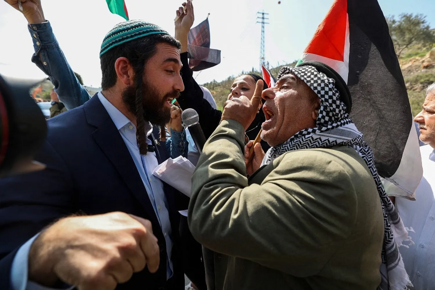 Knesset (Parliament) member for Israel's Religious Zionism party Tzvi Sukkot (L) is confronted as he tries to interrupt a rally by Palestinian and Israeli peace activists protesting at the entrance of Huwara in the occupied West Bank, on March 3, 2023, following deadly violence by Israeli settlers. (AFP) 