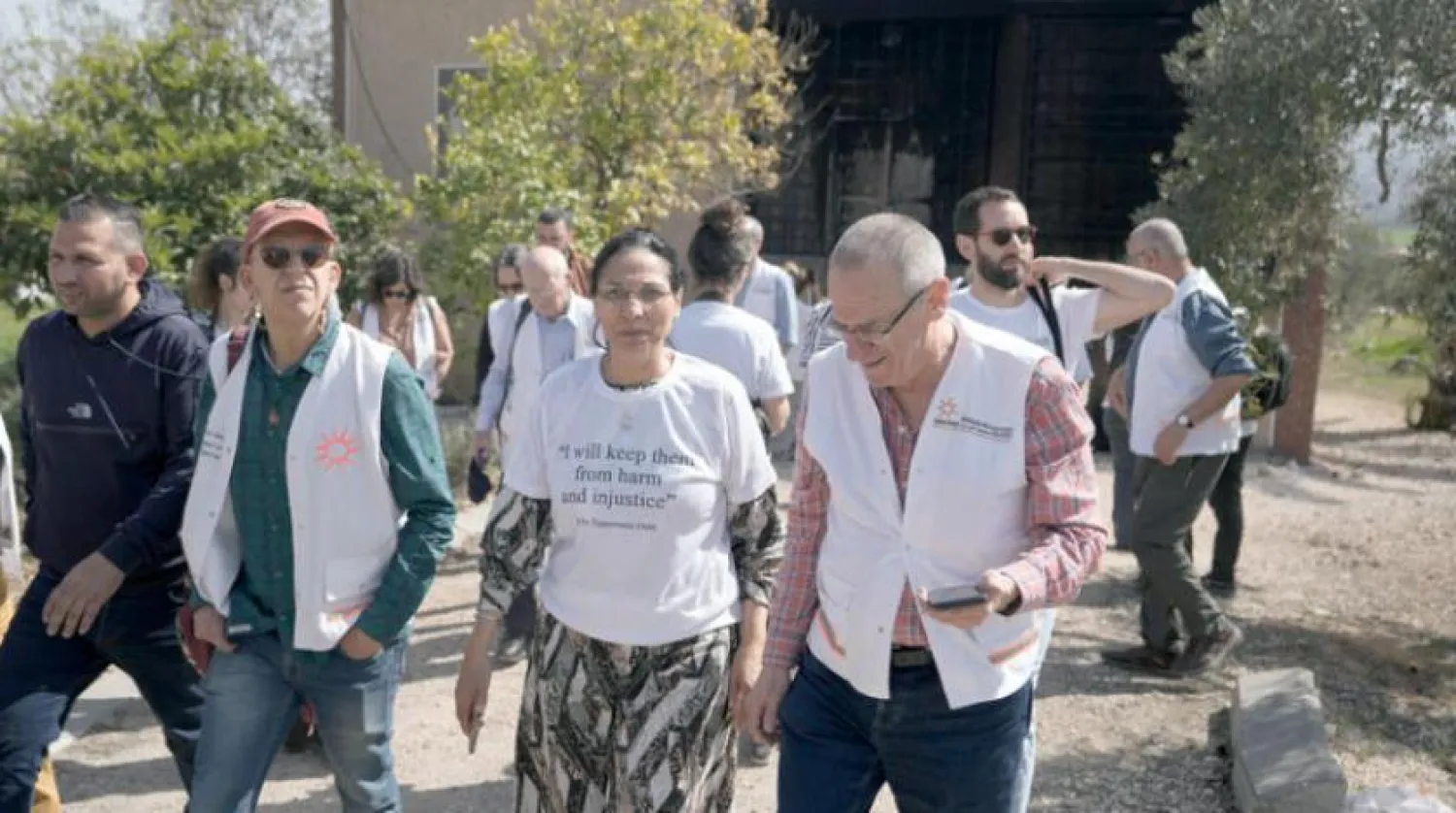 A delegation from Physicians for Human Rights-Israel survey the aftermath of a rampage by settlers in Huwara, near the West Bank city of Nablus on Wednesday, March 1, 2023 (AP)

