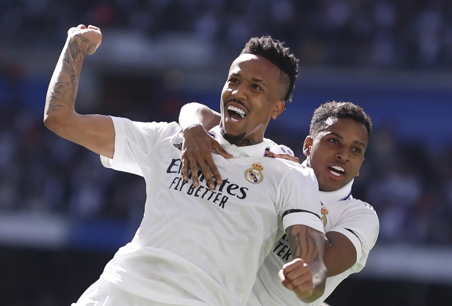 Real Madrid's Brazilian defender Éder Militão (front) celebrates with his teammate Rodrygo after scoring the 2-1 lead during the LaLiga match Real Madrid vs Espanyol at Santiago Bernabeu Stadium, in Madrid, Spain, 11 March 2023. (EPA)