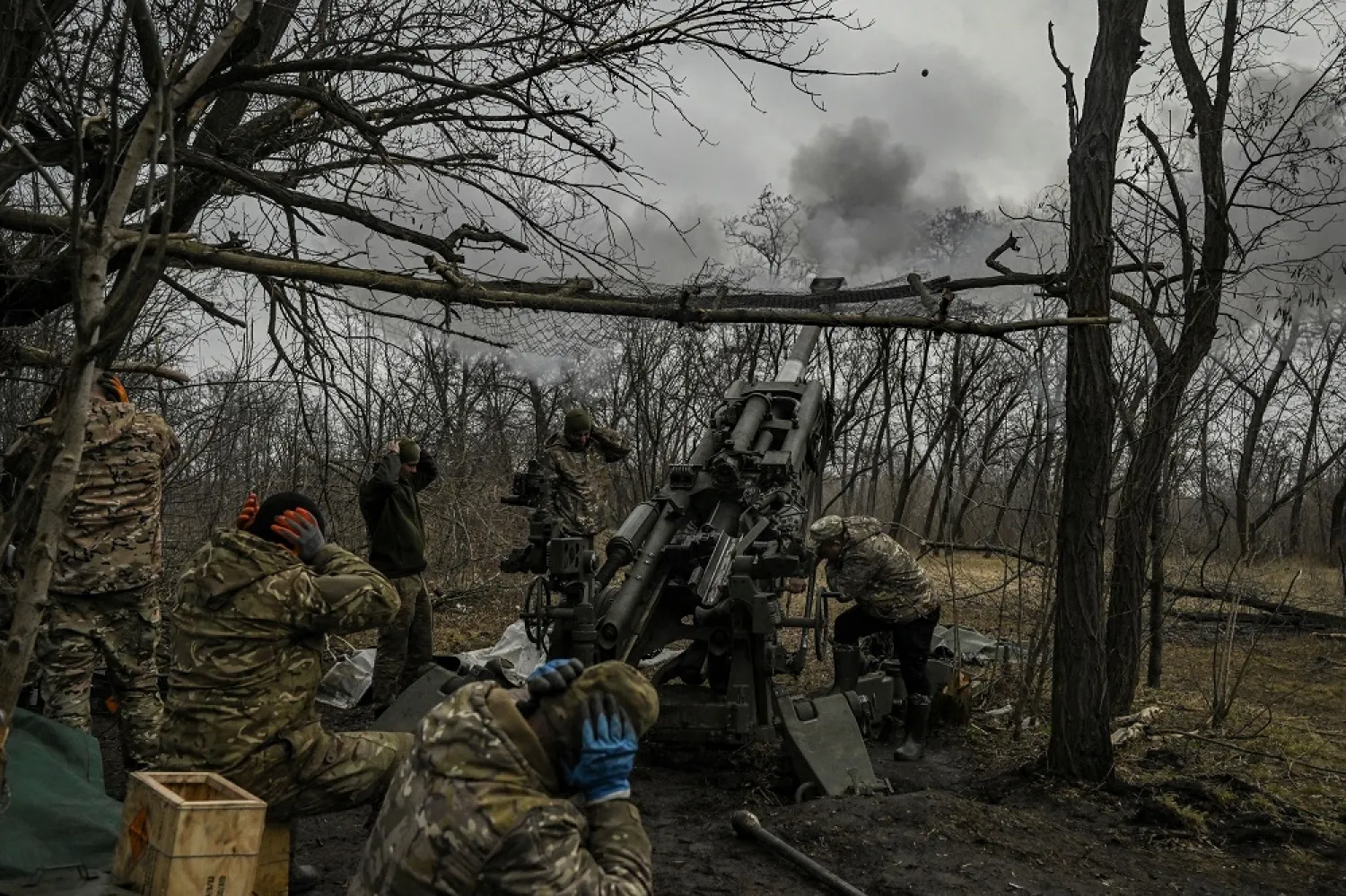 Ukrainian servicemen fire towards Russian positions with a 155mm M777 Howitzer artillery weapon on the front line somewhere near the city of Bakhmut on March 11, 2023 amid the Russian invasion of Ukraine. (AFP) 