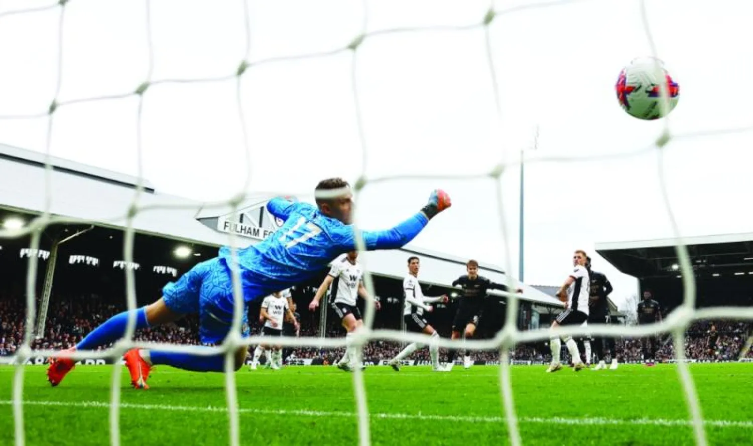 برند لينو حارس فولهام في محاولة يائسة للتصدي لتسديدة أوديغارد نجم آرسنال (رويترز)