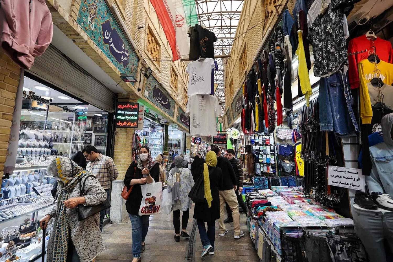People shop at a market in Tehran on March 14, 2023, ahead of the Nowruz New Year festival. (AFP)