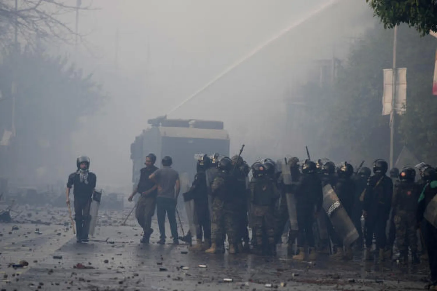 Police use water cannon to disperse supporters of former Prime Minister Imran Khan during clashes, in Lahore, Pakistan, Wednesday, March 15, 2023. (AP Photo/K.M. Chaudary)
