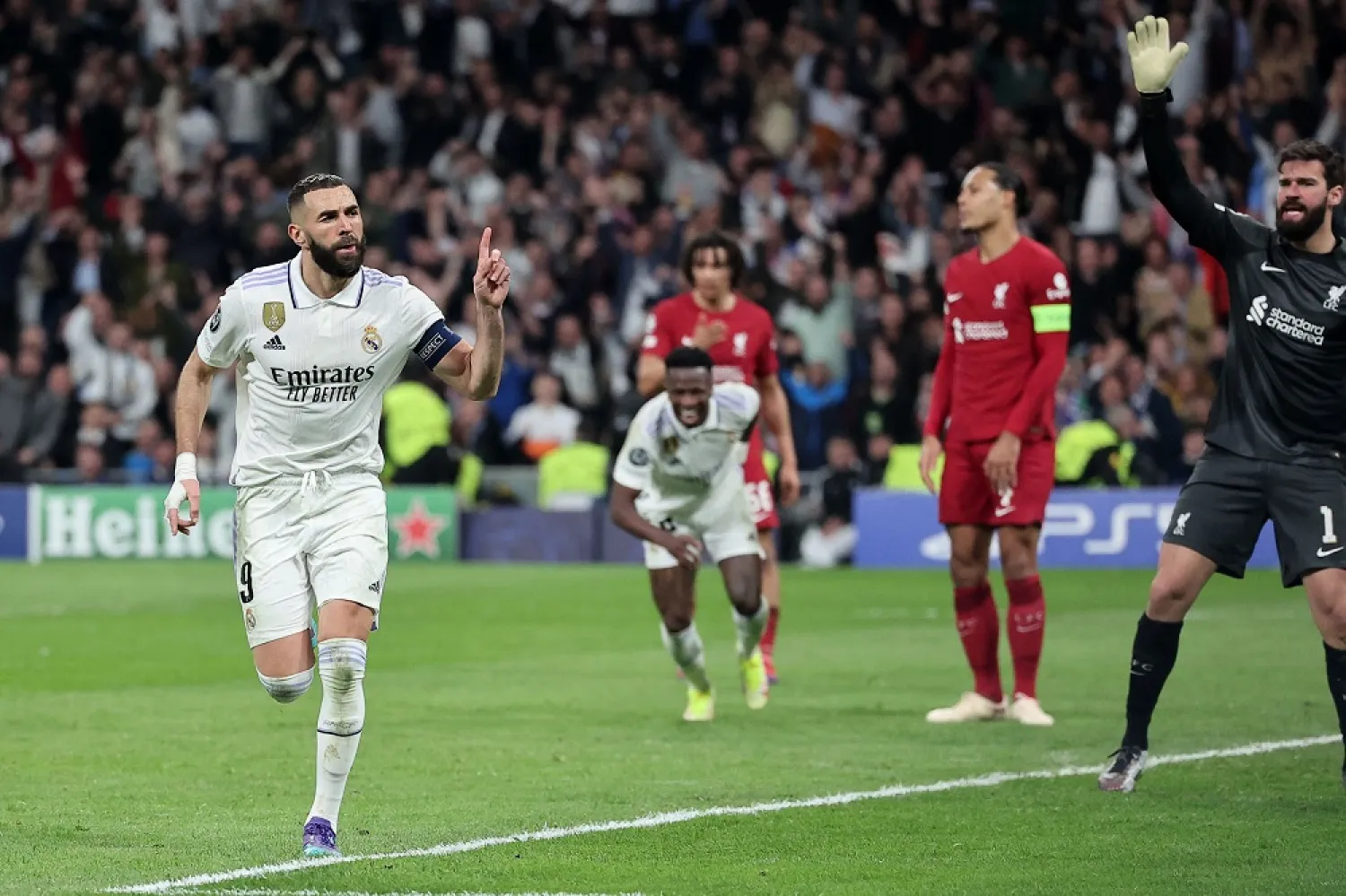 Real Madrid's French forward Karim Benzema (L) celebrates scoring his team's first goal during the UEFA Champions League last 16 second leg football match between Real Madrid CF and Liverpool FC at the Santiago Bernabéu stadium in Madrid on March 15, 2023. (AFP)