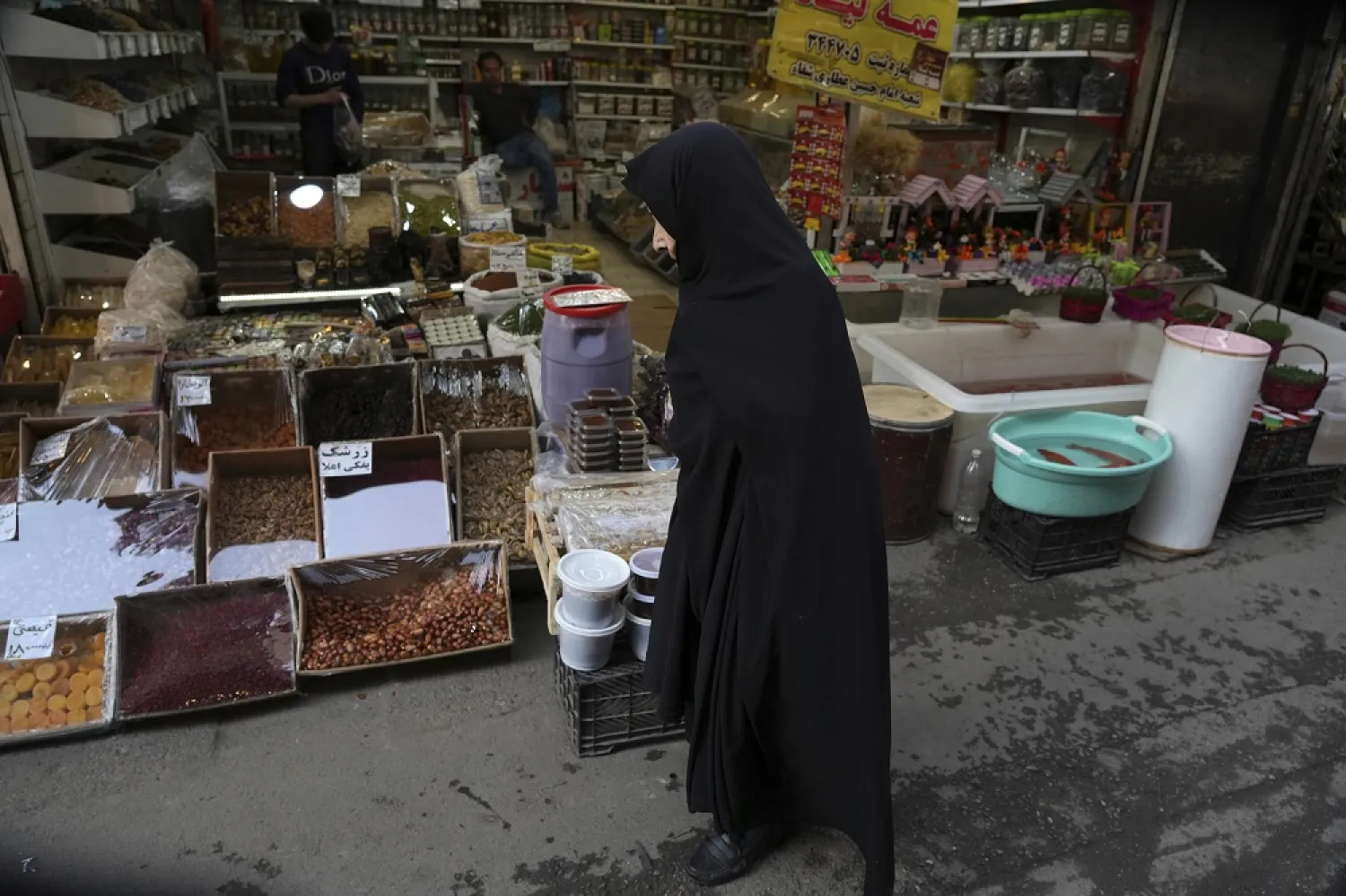 A woman walks through a local market in Tehran, Iran, ahead of the Persian new year, known as Nowruz, Wednesday, March 15, 2023. (AP)
