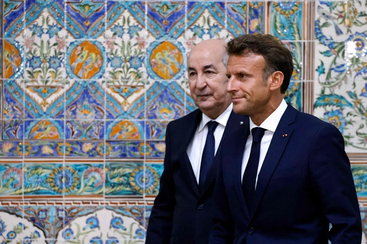 French President Emmanuel Macron (R) and Algeria's President Abdelmadjid Tebboune (L) leave at the end of a joint press conference at the presidential palace in Algiers, Algeria, Aug. 25, 2022. (AFP)