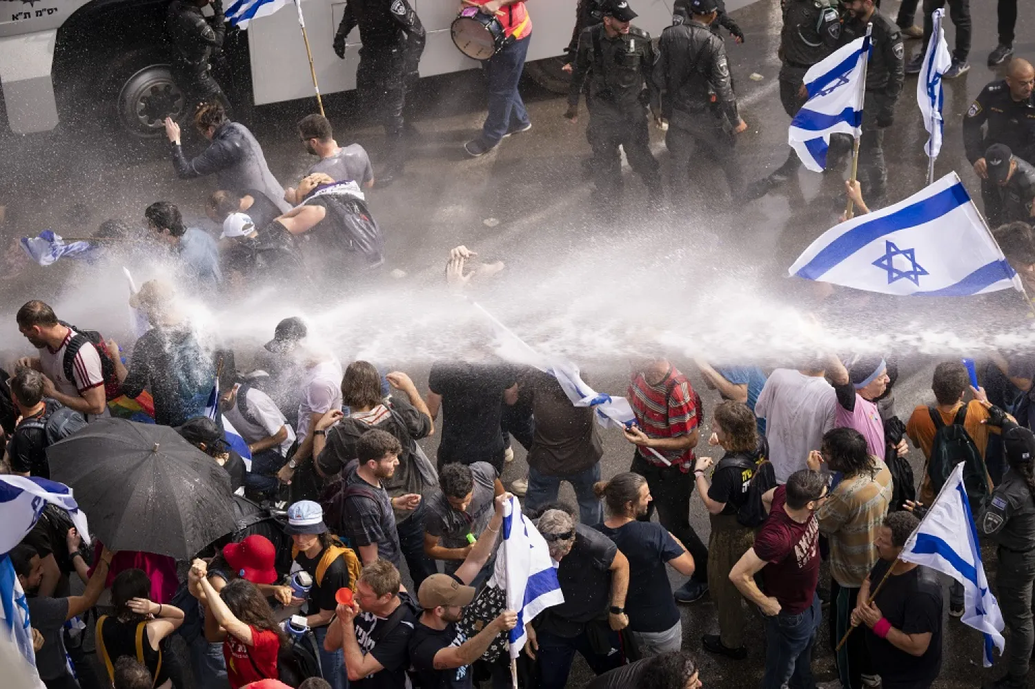 Israeli police use a water cannon to disperse Israelis blocking the freeway during a protest against plans by Prime Minister Benjamin Netanyahu's government to overhaul the judicial system in Tel Aviv, Israel, Thursday, March 23, 2023. (AP)
