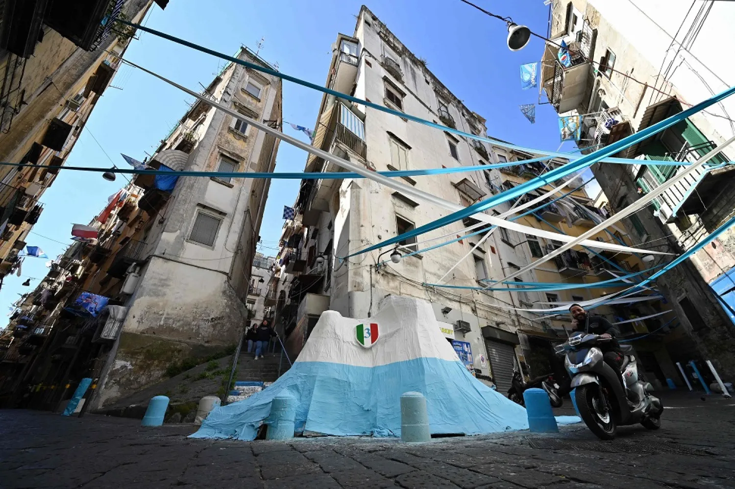 Flags and banners decorate the Quartieri Spagnoli on March 24, 2023 in Naples, as the city braces up for its potential first Scudetto championship win in 33 years. (AFP)