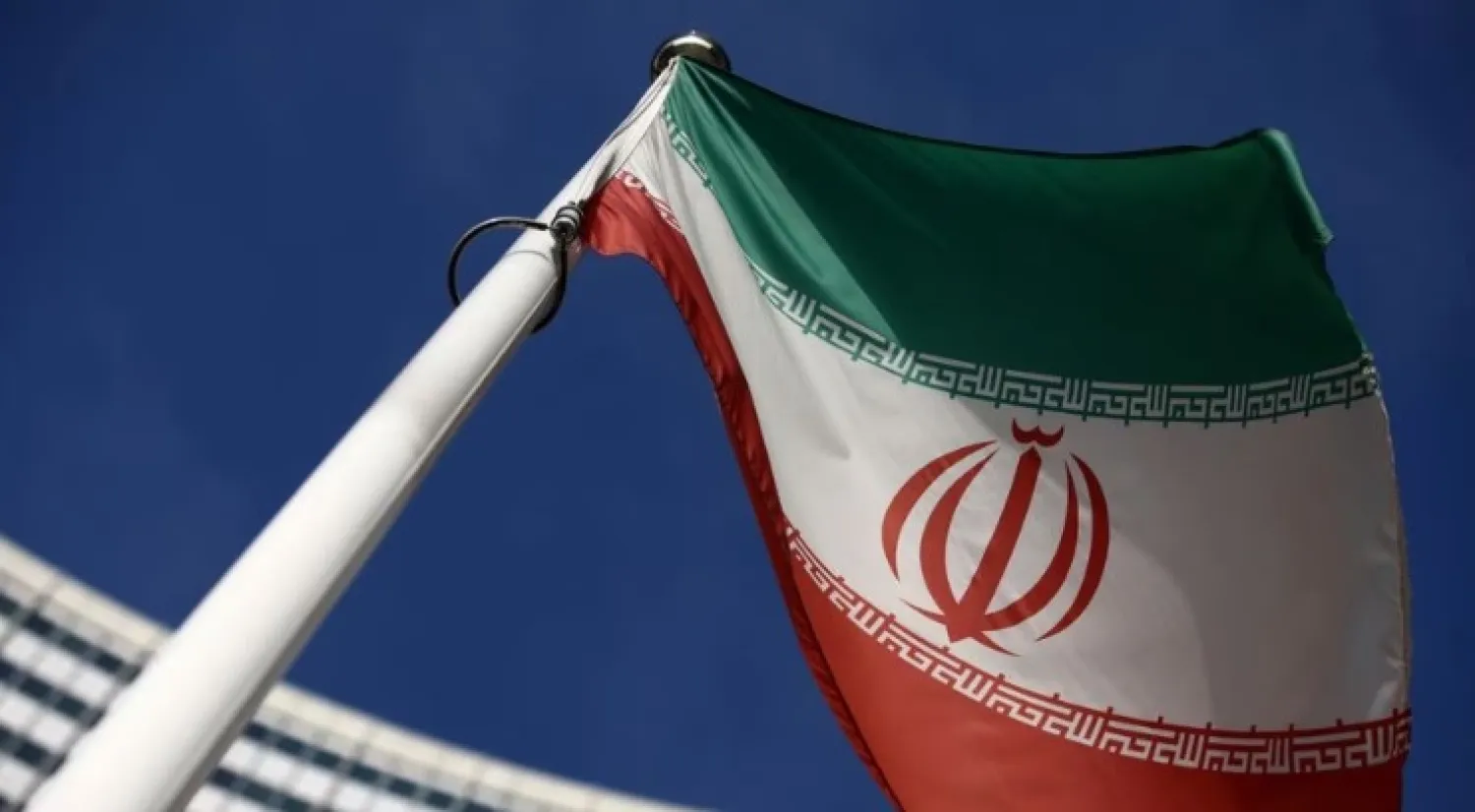 The Iranian flag waves in front of the International Atomic Energy Agency (IAEA) headquarters, before the beginning of a board of governors meeting in Vienna, Austria, March 1, 2021. REUTERS/Lisi Niesner/File Photo