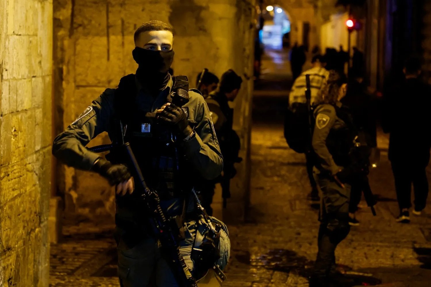 Israeli forces stand outside al-Aqsa compound as they evict Palestinians during the holy month of Ramadan in Jerusalem's Old City, March 26, 2023. (Reuters)