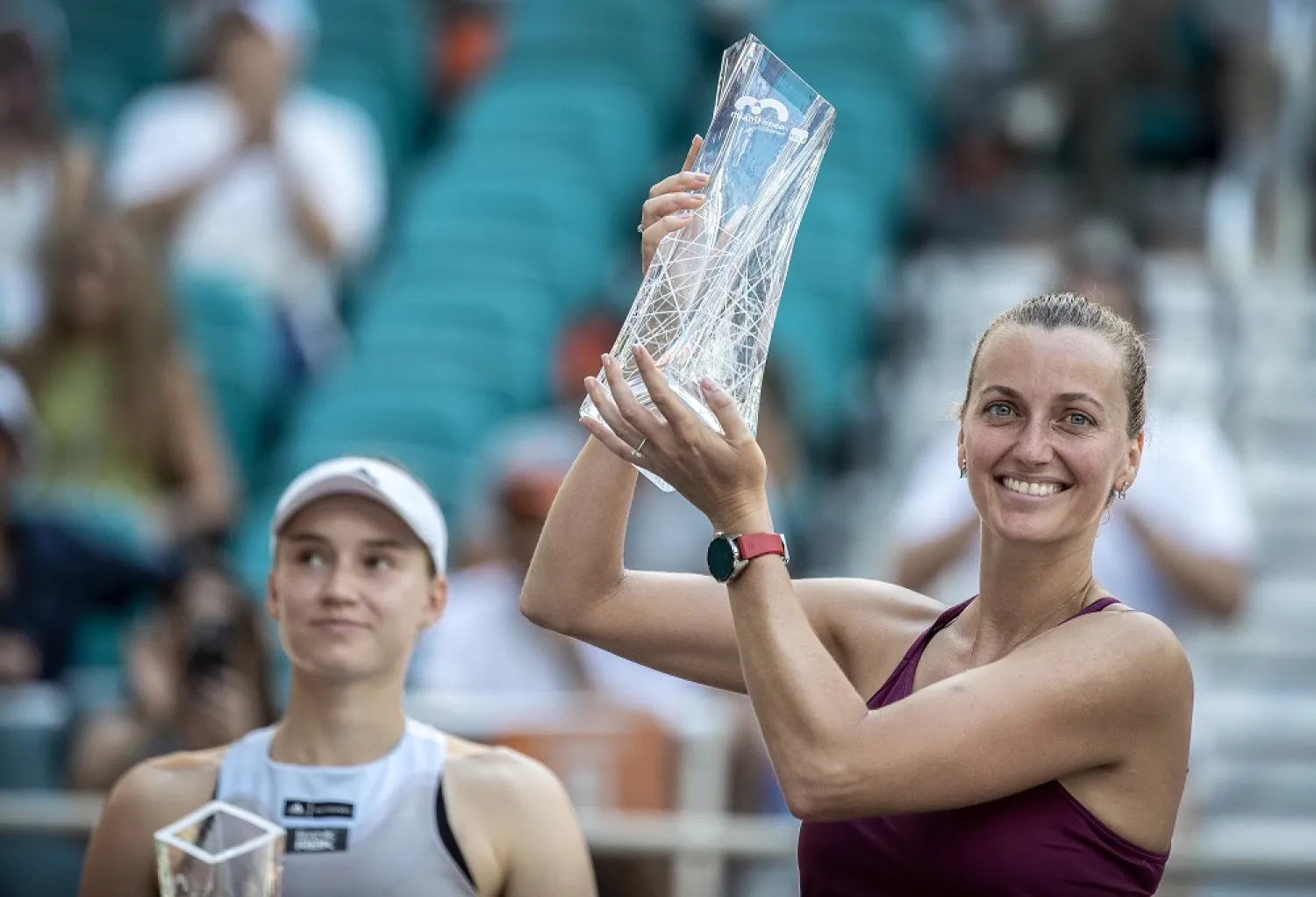Petra Kvitova of the Czech Republic (R) holds the 2023 Miami Open Trophy after she won the match against Elena Rybakina of Kazakhstan (L) during the Women’s Singles Final of the 2023 Miami Open tennis tournament at the Hard Rock Stadium in Miami, Florida, USA, 01 April 2023. (EPA)