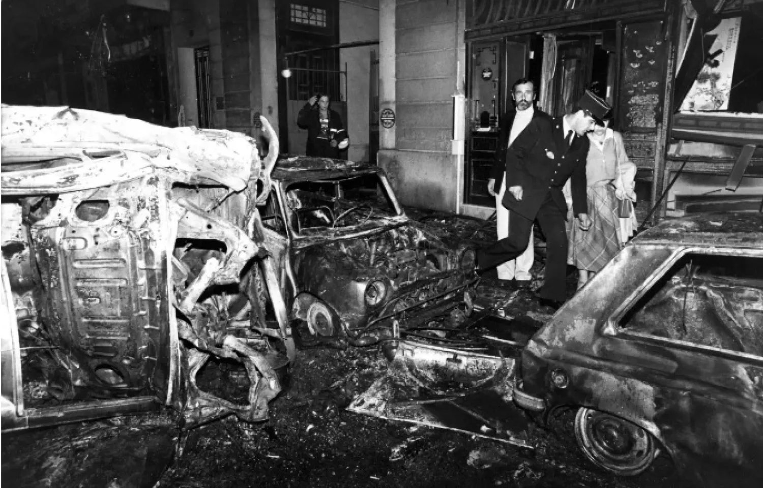FILE - A police officer walks at the scene after the bombing of the Copernic street synagogue, in Paris, that killed 4 people on This Oct. 3, 1980. (AP Photo/Remy de la Mauviniere, File)