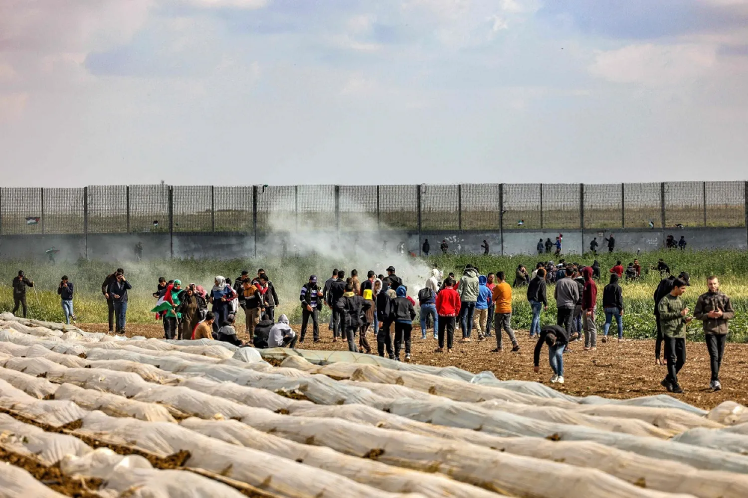 Tear gas fumes are seen as Palestinian protesters gather during the 47th annual Land Day demonstration along the Gaza-Israel border east of Gaza City on March 30, 2023. (AFP)