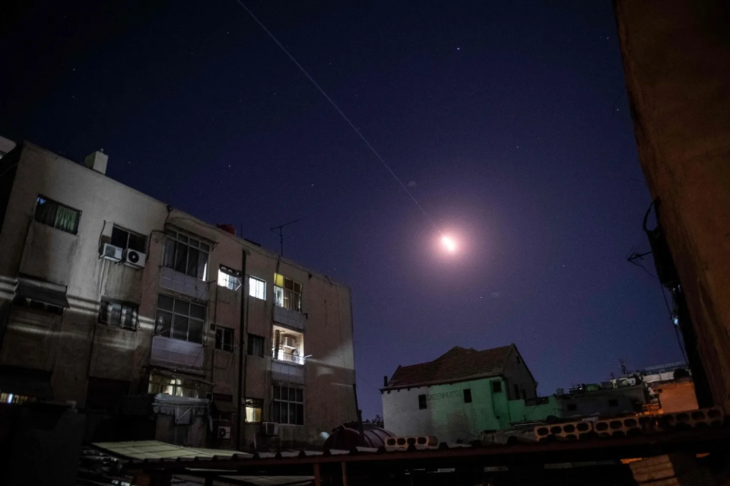 Flares of Syrian air defense rockets are seen in the sky of Damascus on April 4, 2023. (AFP)
