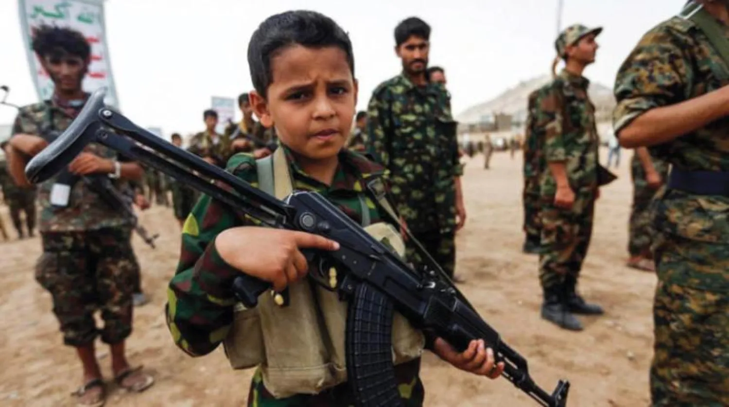 A child, recruited by the Houthis, is seen with a weapon during a rally in Sanaa. (AFP)