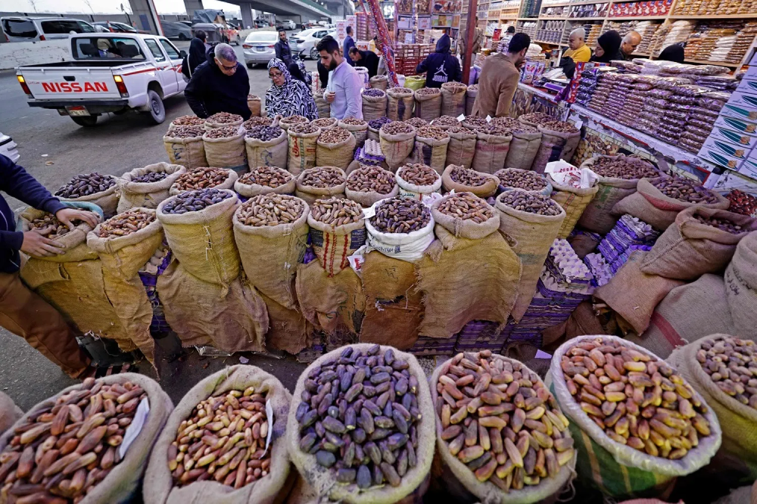 In this picture taken on March 22, 2023 people shop for dates at the traditional Rod el-Farag market in northern Cairo. (AFP)
