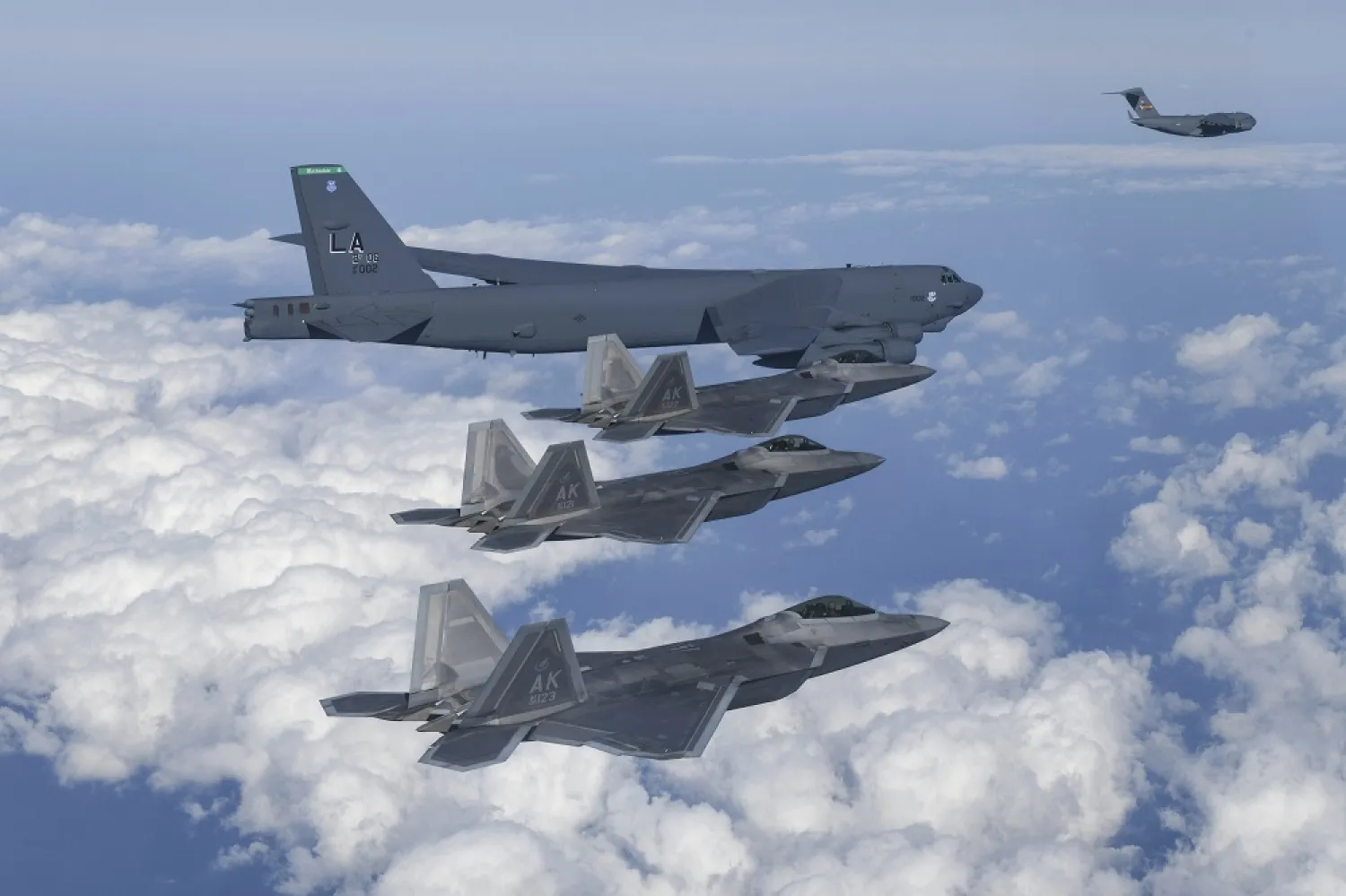 In this photo provided by South Korean Defense Ministry, a US B-52 bomber, C-17, and US Air Force F-22 fighter jets fly over the Korean Peninsula during a joint air drill in South Korea on Dec. 20, 2022. (South Korean Defense Ministry via AP, File)
