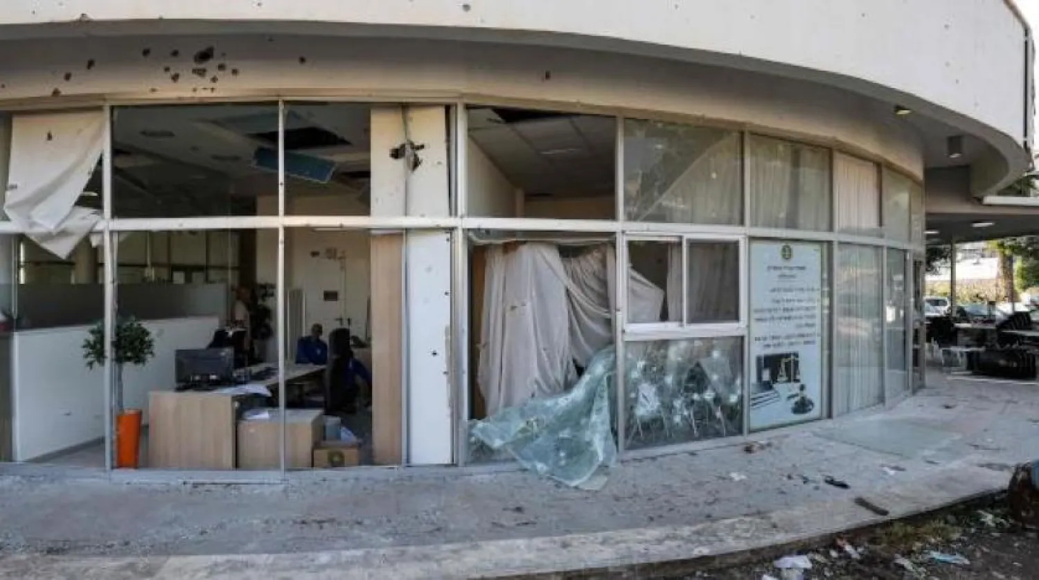 This picture taken on April 6, 2023 shows a view of the damaged glass facade of a building in the aftermath of intercepted rocket fire launched from Lebanon and intercepted by Israel in its northern town of Shlomi. (Photo by Jalaa MAREY / AFP)