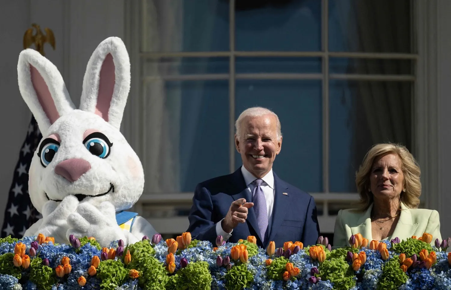 US President Joe Biden, alongside First Lady Jill Biden waves after speaking at the annual Easter Egg Roll on the South Lawn of the White House in Washington, DC, on April 10, 2023. (AFP)