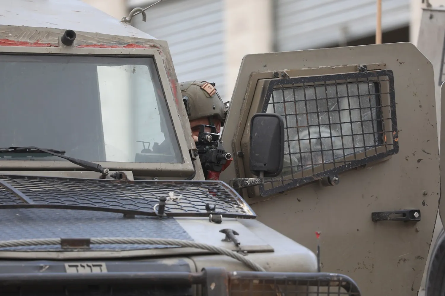 An Israeli soldier takes position in the area where two Palestinian militants were killed, near the settlement of Elon Moreh near the west bank city of Nablus, 11 April 2023. (EPA)